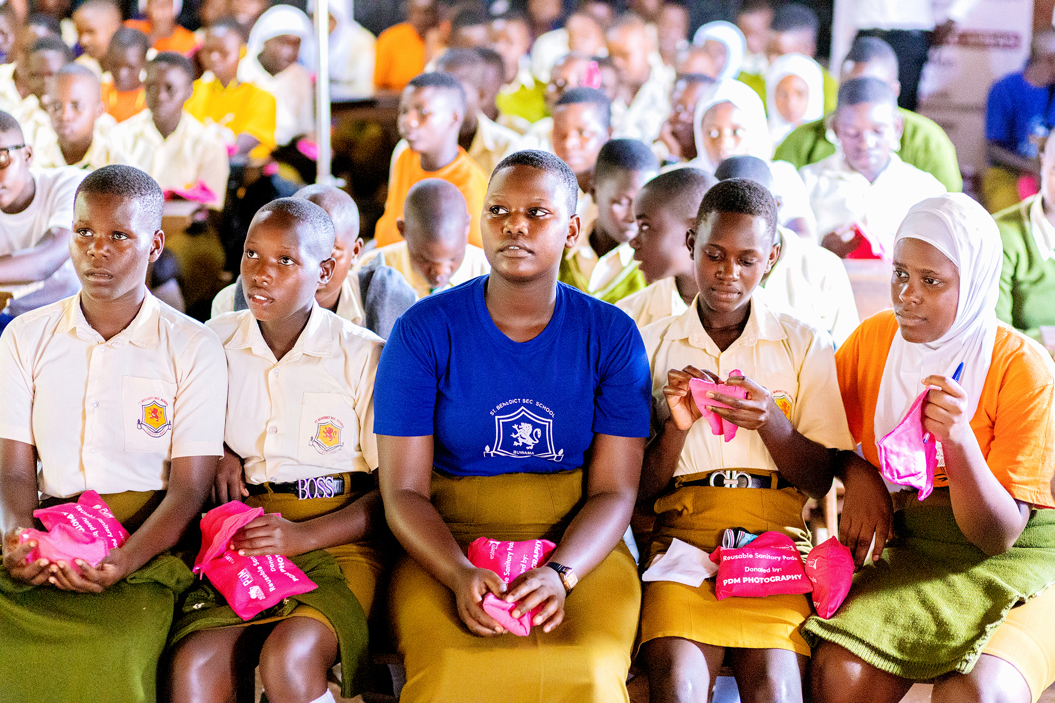 Students holding reusable sanitary pads
